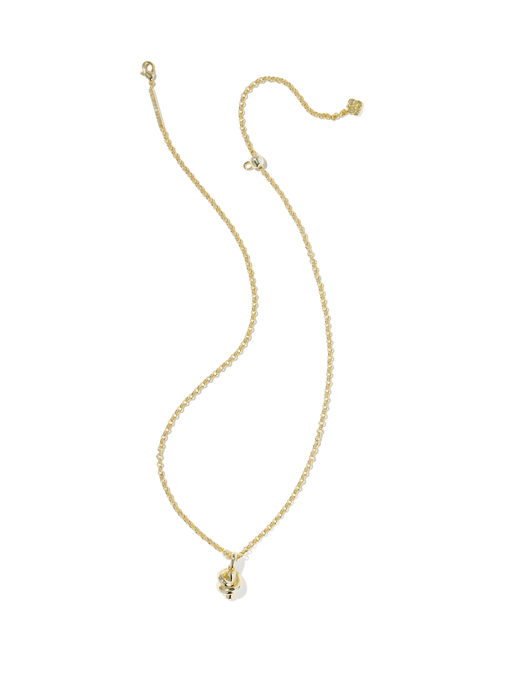 A delicate gold chain necklace with a small skull pendant, displayed on a clean white background.