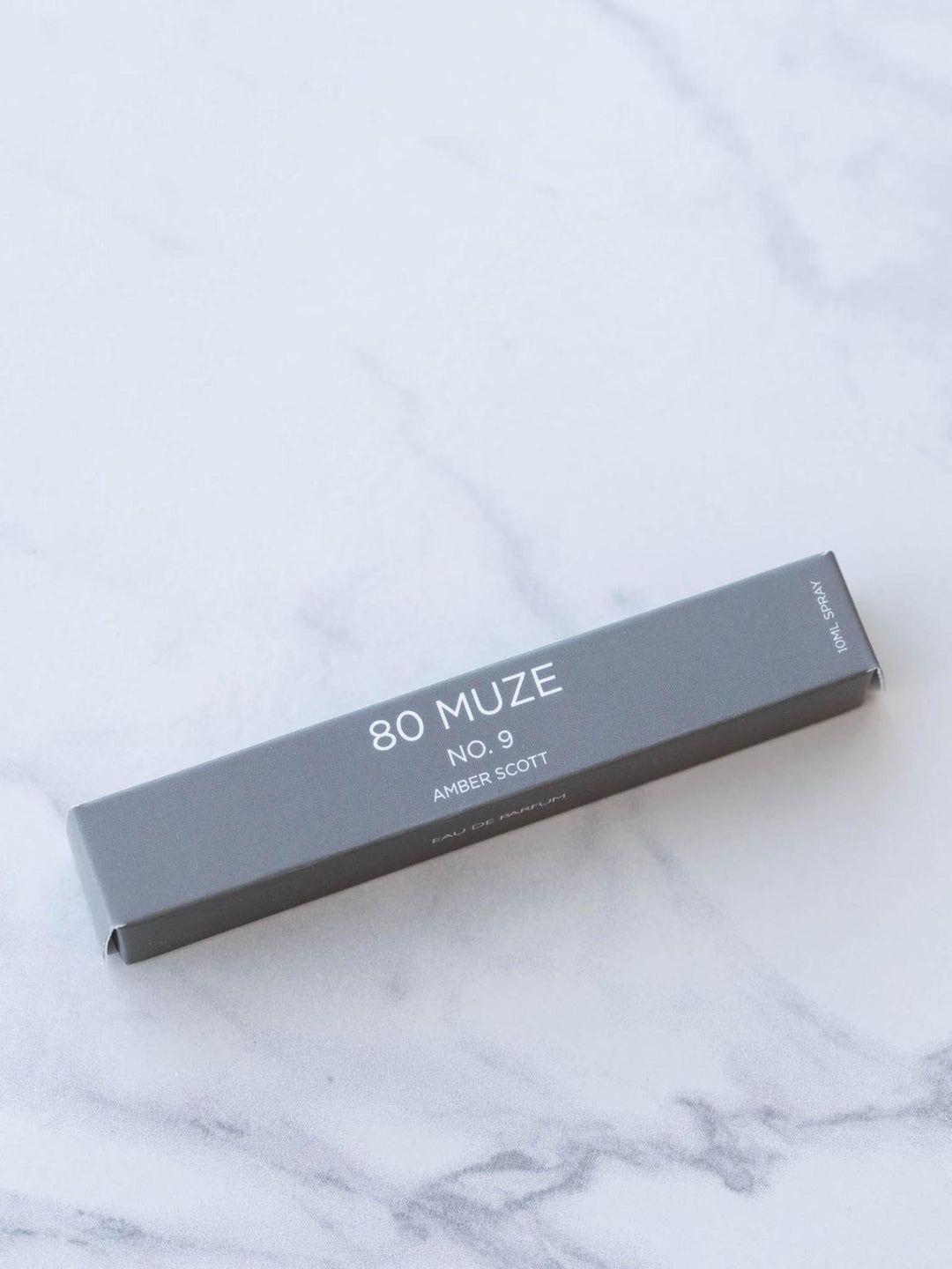 80 MUZE product packaging on a marble surface