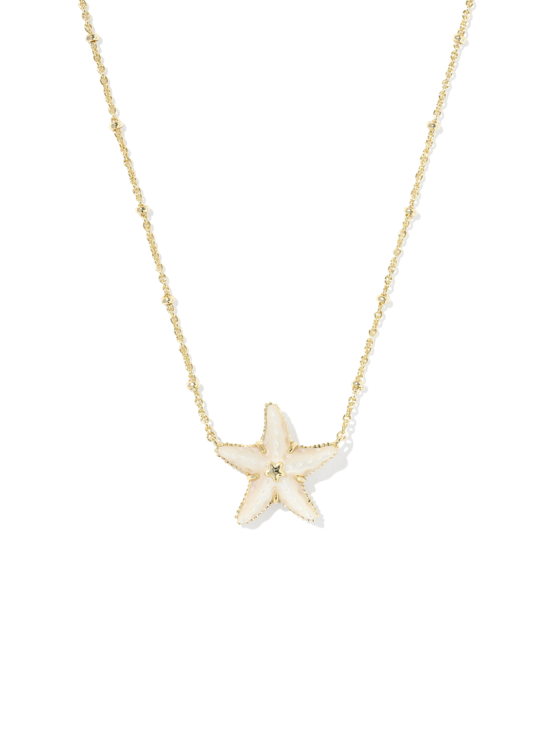 A delicate gold chain necklace featuring a small, five-pointed starfish pendant with a textured cream center, displayed against a solid white background.