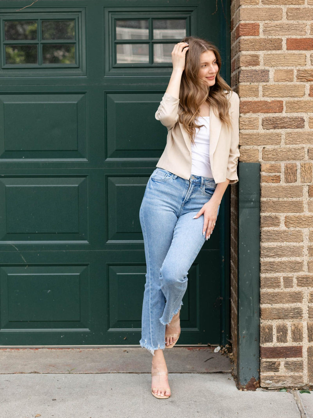 Woman in Allie Rose Natural linen blend cropped blazer, white top, and jeans.