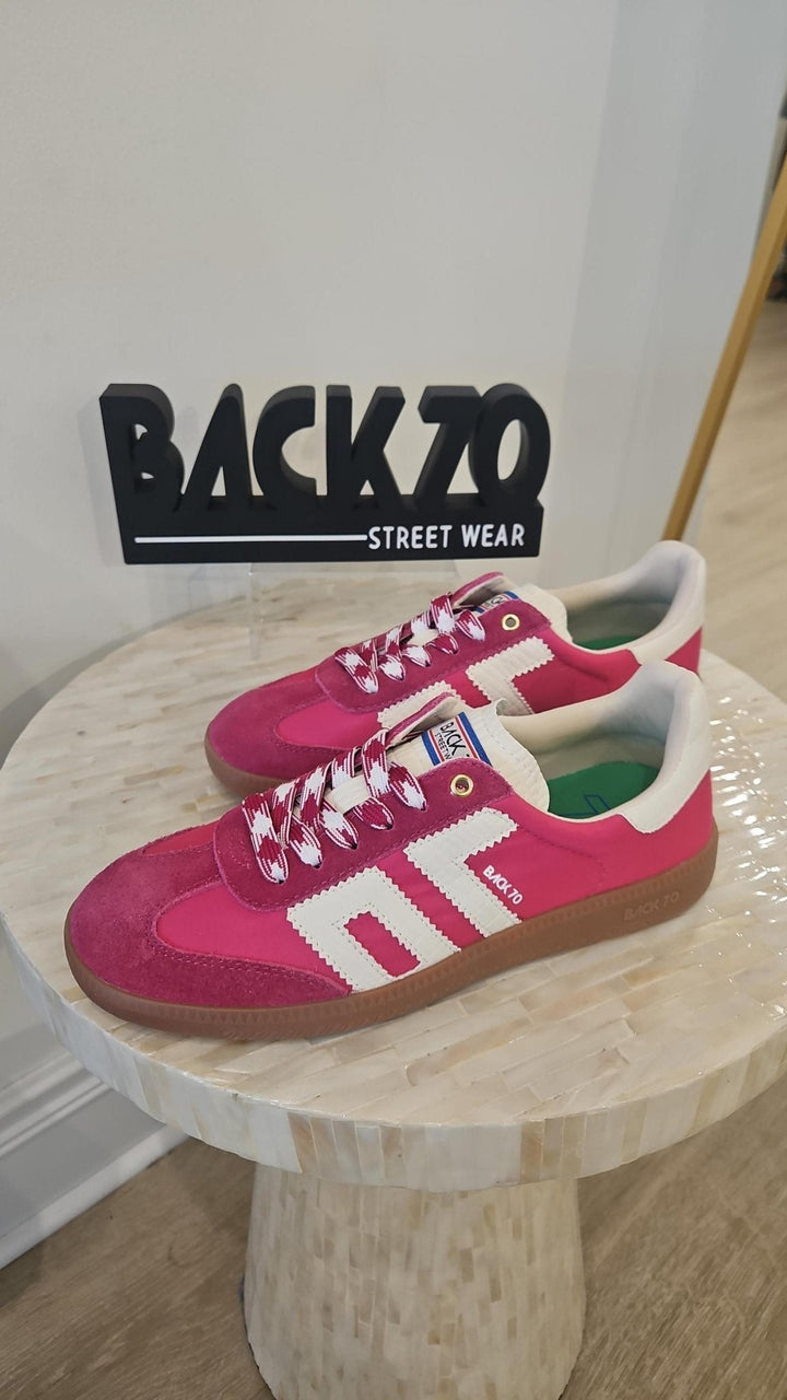 Pink and white sneakers on a wooden stool with &