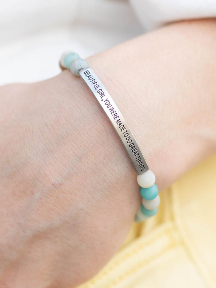 Hand wearing a "Beautiful Girl" Amazonite stone bracelet with an engraved silver bar.