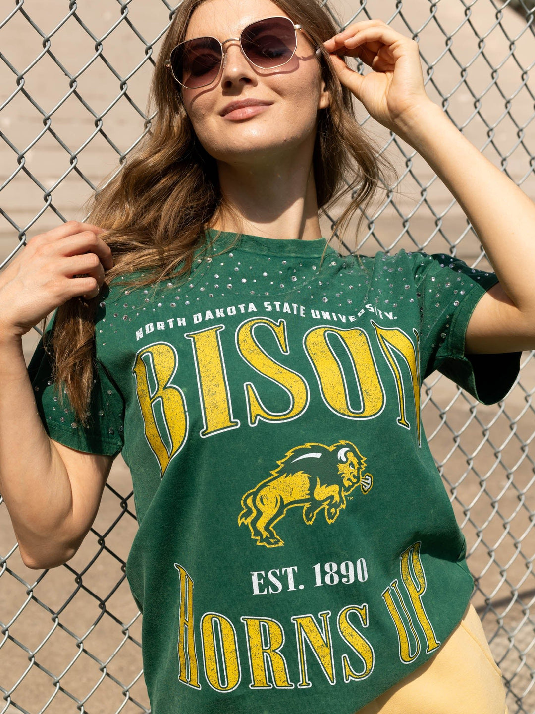 A woman wearing a green North Dakota State University &