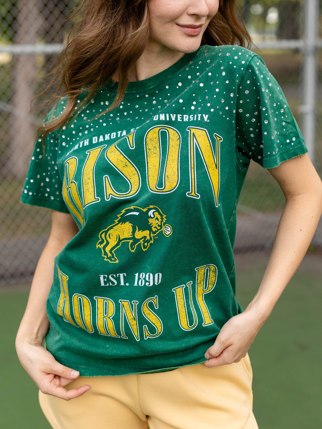 A woman wearing a green University of Nebraska &