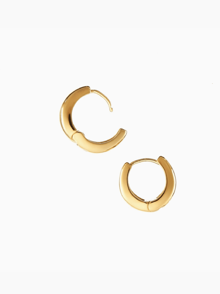 Gold hoop earrings on a white background