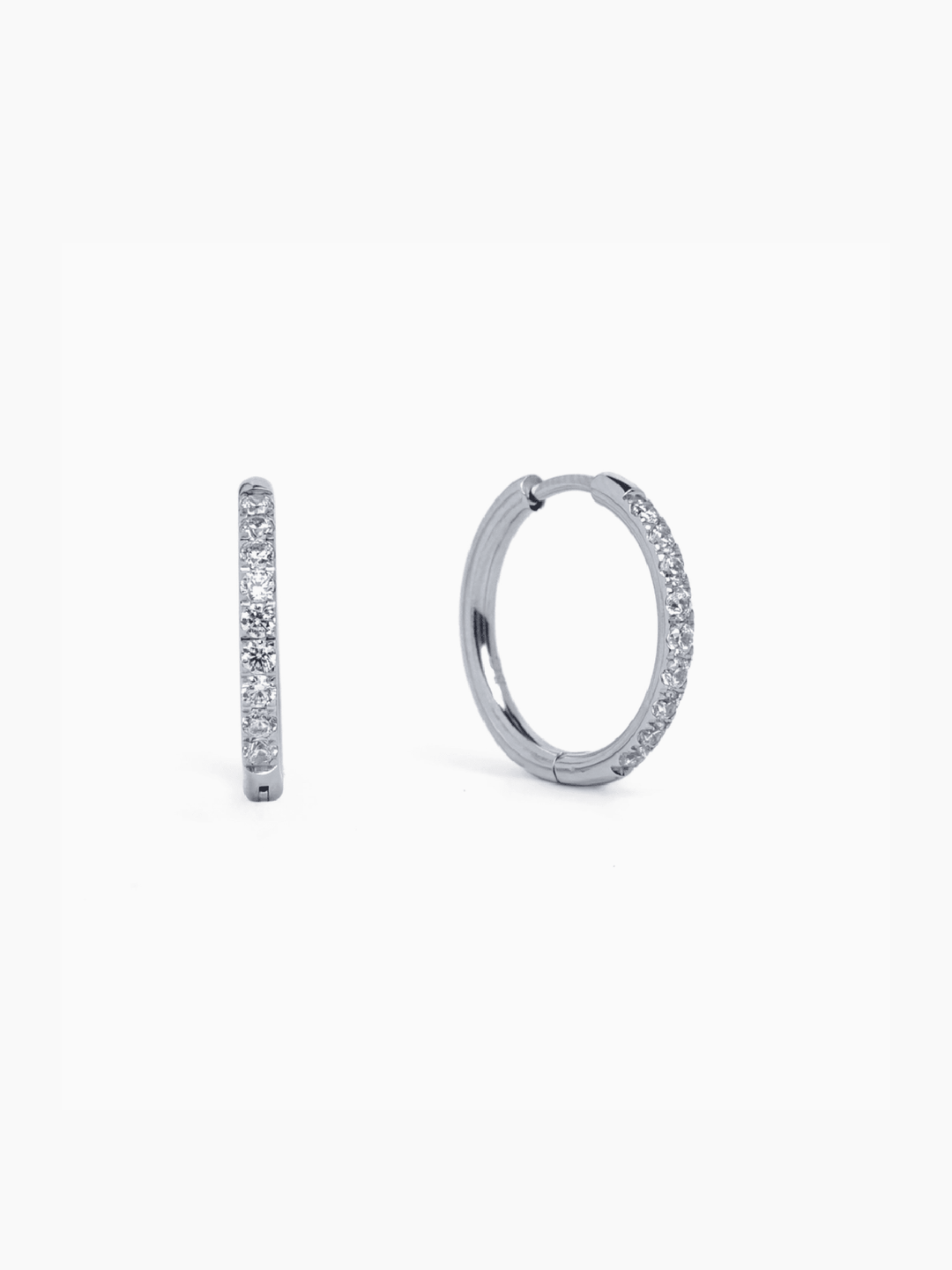 Pair of silver hoop earrings with embedded stones on a white background
