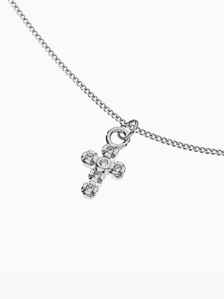 Silver cross pendant necklace on a white background