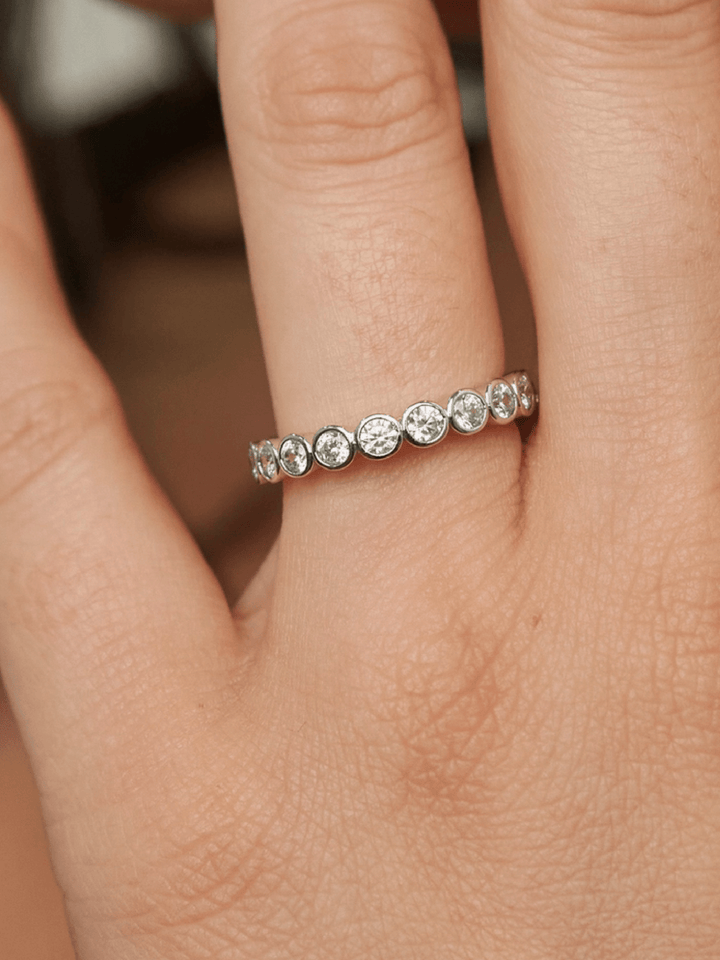 Silver ring with diamonds on a finger