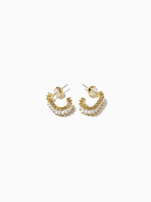 Gold and pearl hoop earrings on a white background