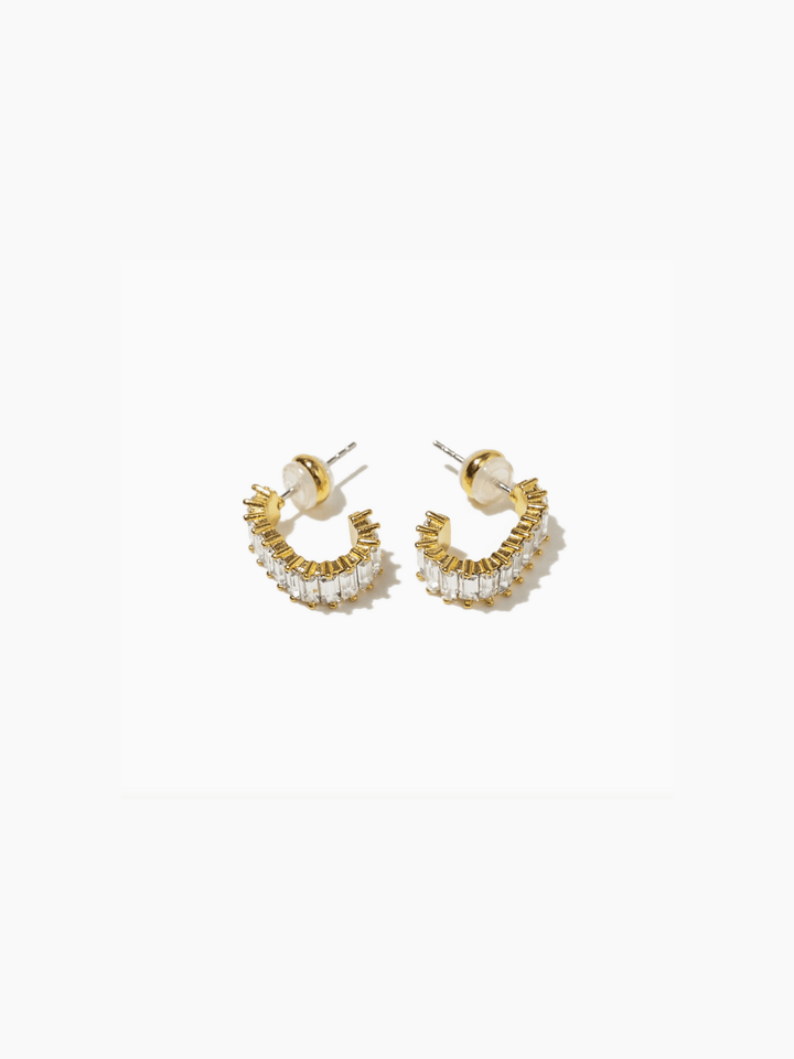 Gold and pearl hoop earrings on a white background