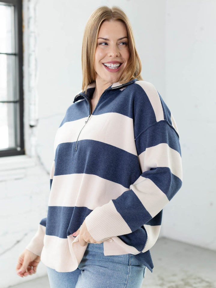 Woman wearing a blue and white striped sweater in a bright room.