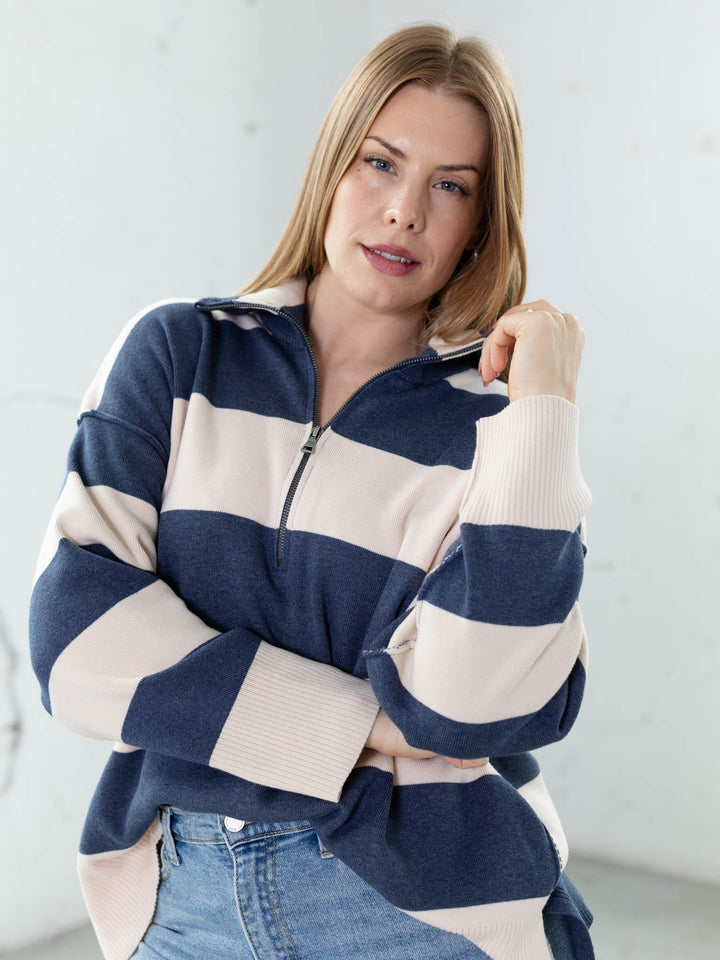 Woman wearing a blue and white striped sweater against a light background
