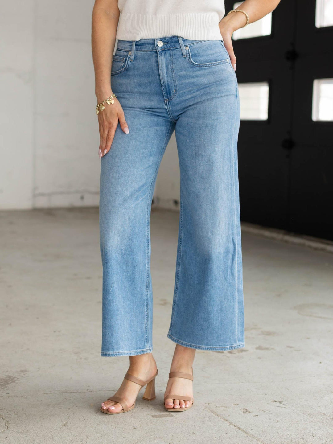 Person wearing light blue jeans in an indoor setting