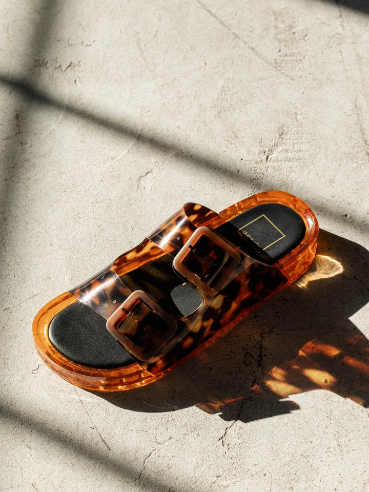 Tortoiseshell sandal on a textured surface