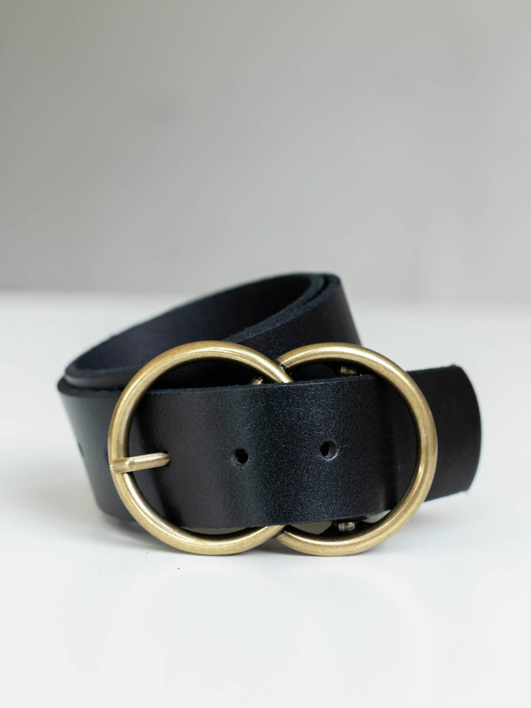 Black genuine leather belt with a gold-toned double circle buckle.