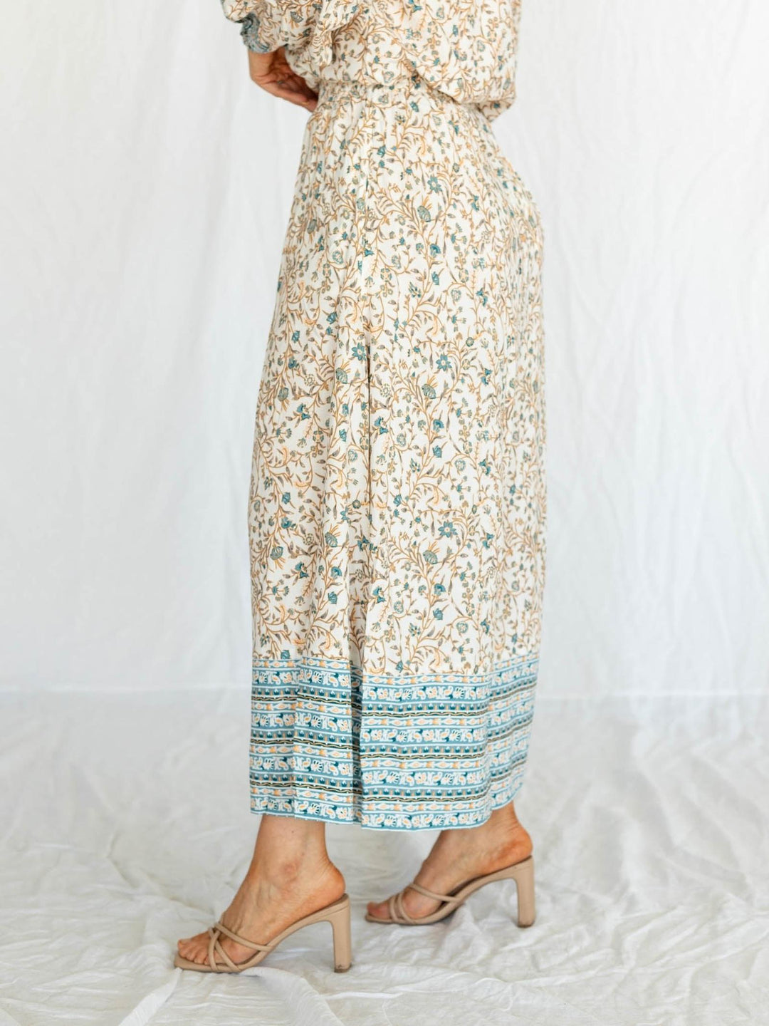 Floral dress with a patterned hem on a white background