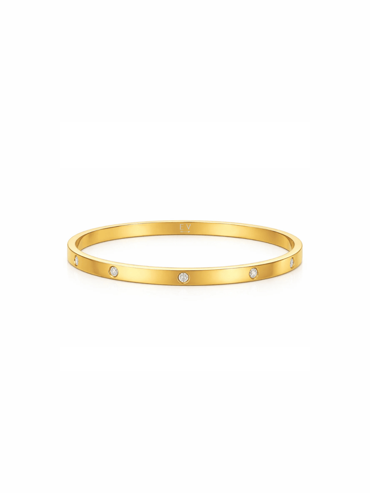 Gold bracelet with small diamonds on a white background