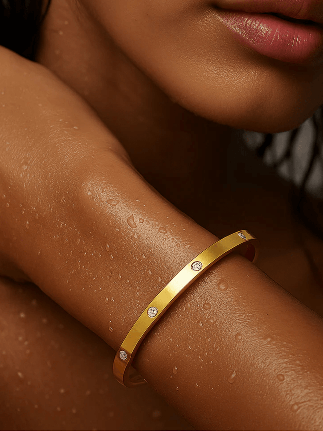 Gold bracelet with small stones on a person&
