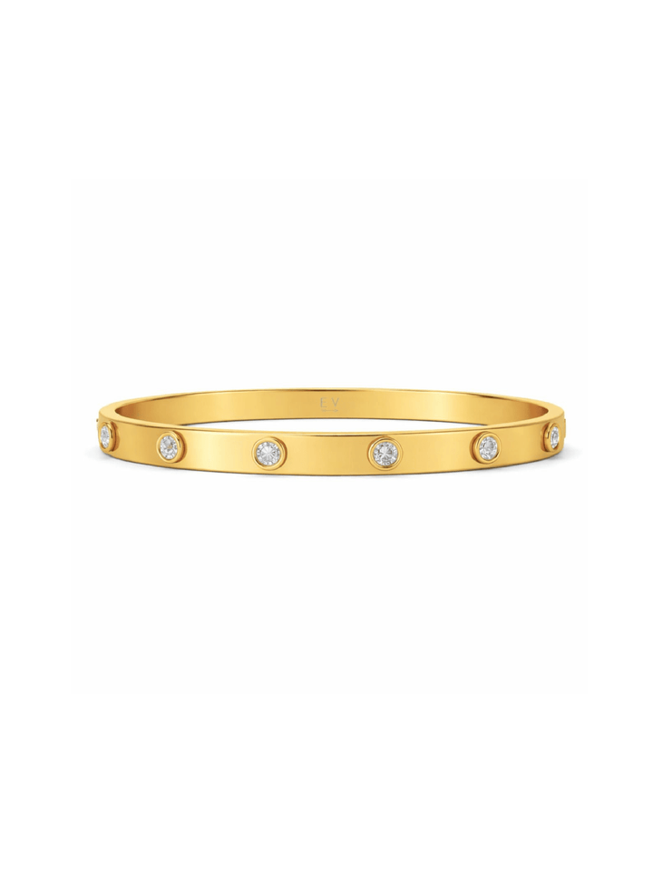 Gold bracelet with embedded diamonds on a white background