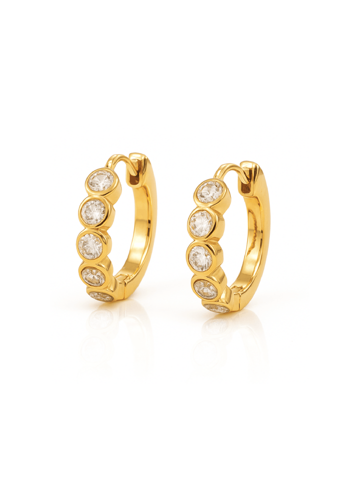 Gold hoop earrings with embedded stones on a white background