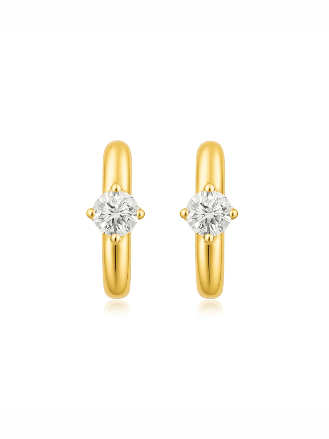 Gold hoop earrings with clear gemstones on a white background