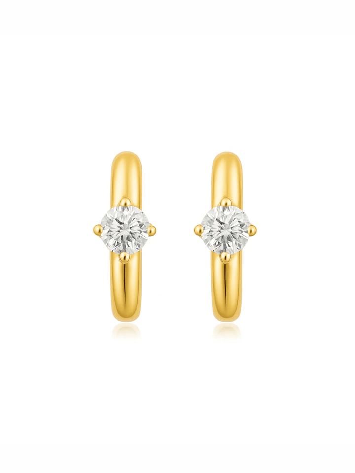 Gold hoop earrings with clear gemstones on a white background
