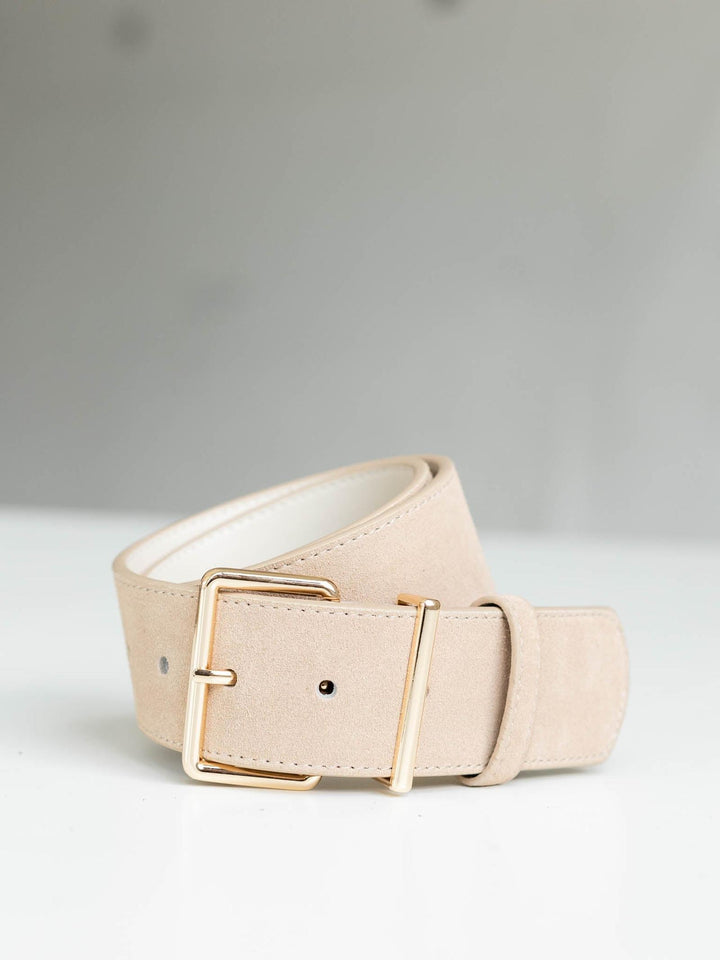 Almond suede belt with a modern angular gold buckle and streamlined silhouette.
