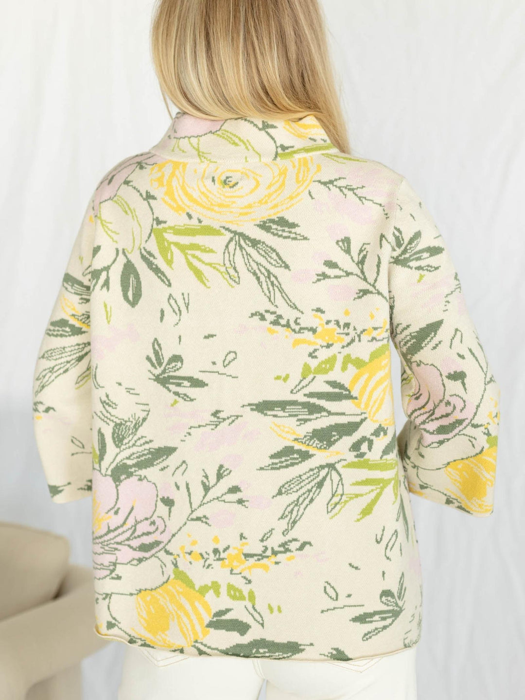Floral patterned shirt worn by a person on a white background