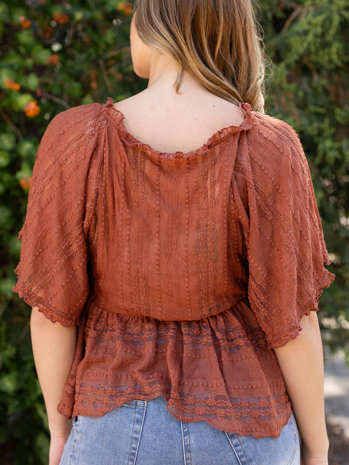 Free People In Your Dreams Lace Top in Toasted Cocoa, featuring delicate lace, 3/4 sleeves, and an asymmetrical hem.