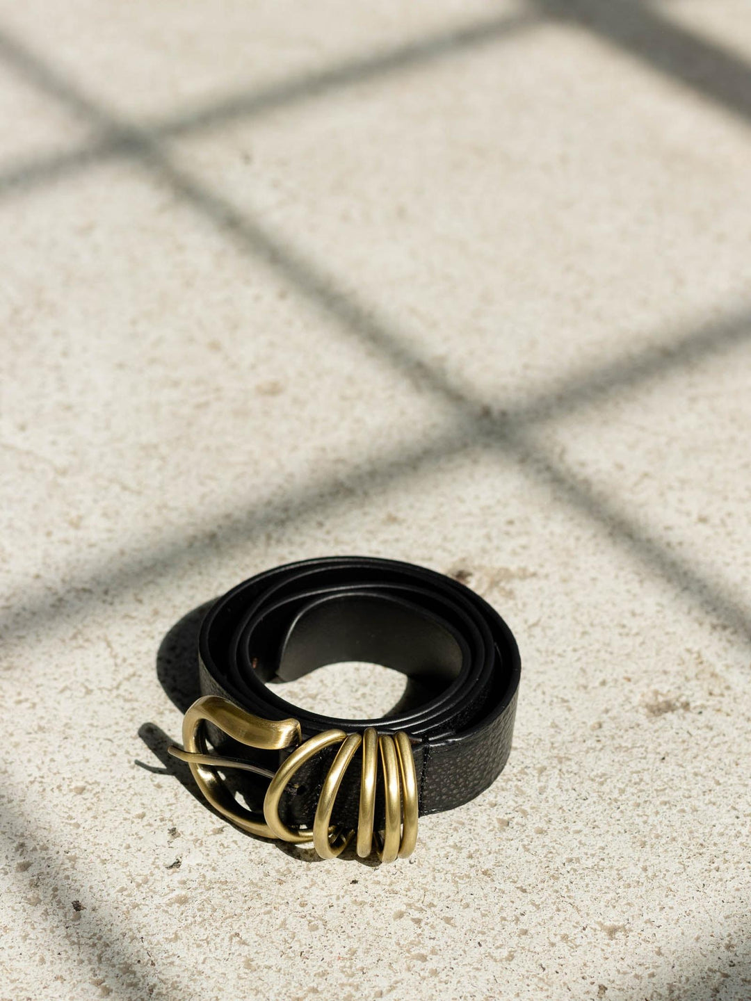 black and gold textured belt