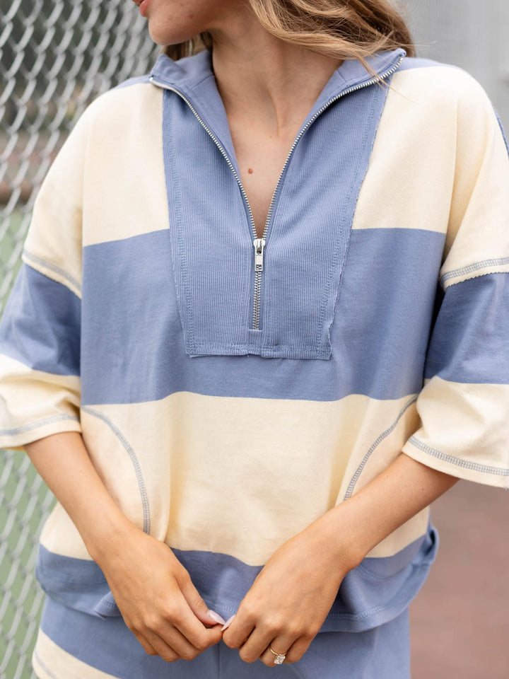 Free People Retro Rugby Set: woman in a cream and blue striped 100% cotton quarter-zip top.
