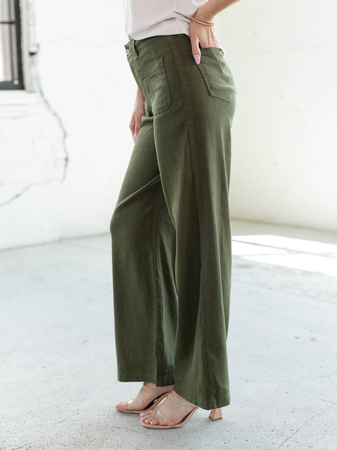 KUT from the Kloth Meg Wide Leg pants in Forest green, side view showing high rise waist and belt loops
