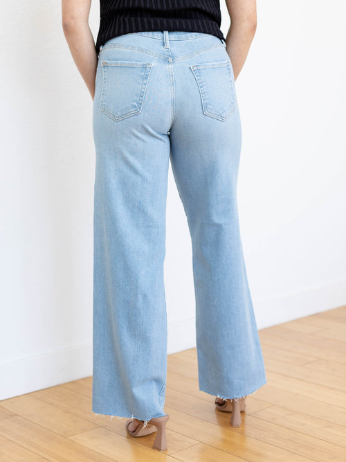 light wash wide leg raw hem denim