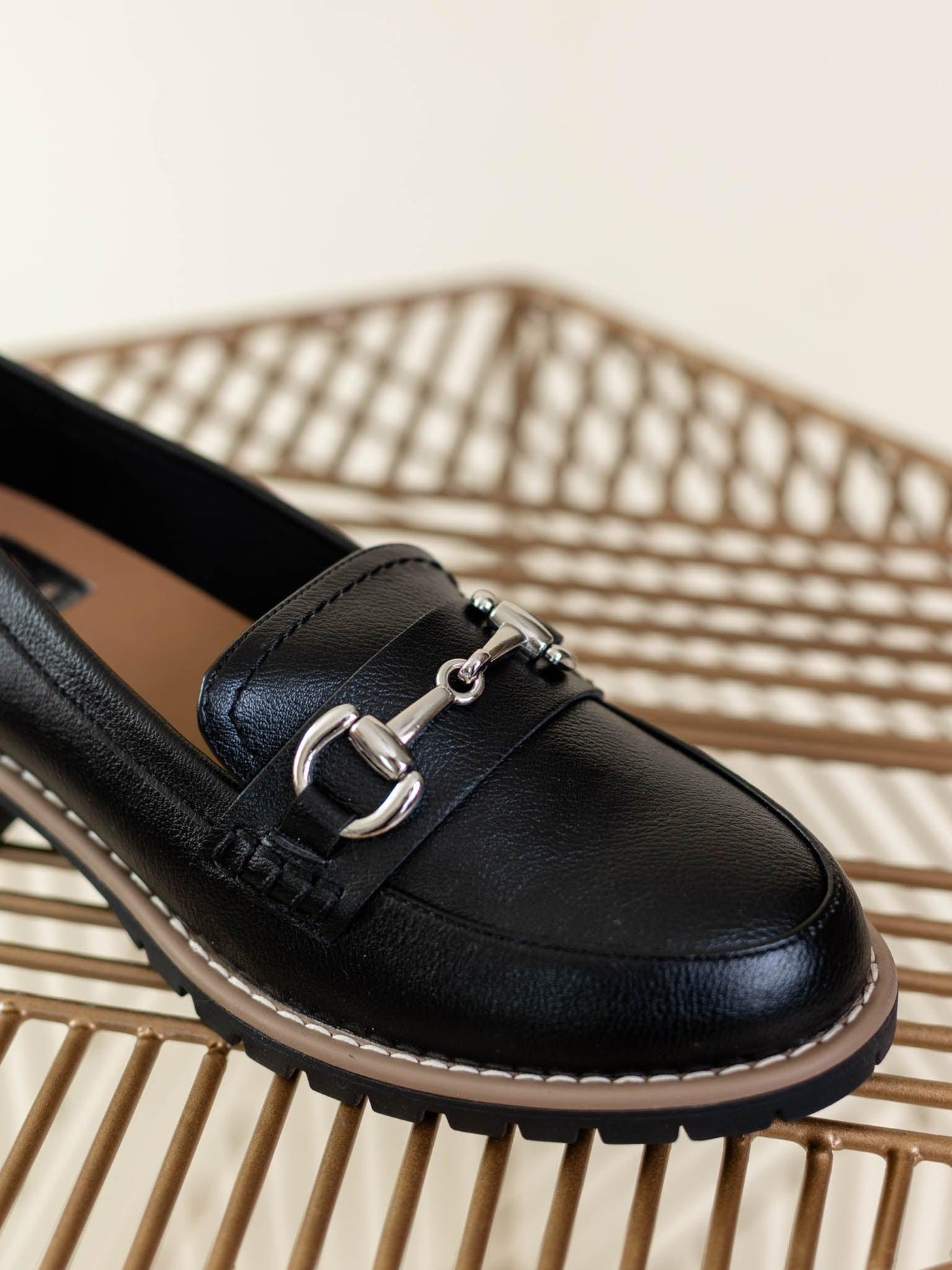 black loafer with silver buckle
