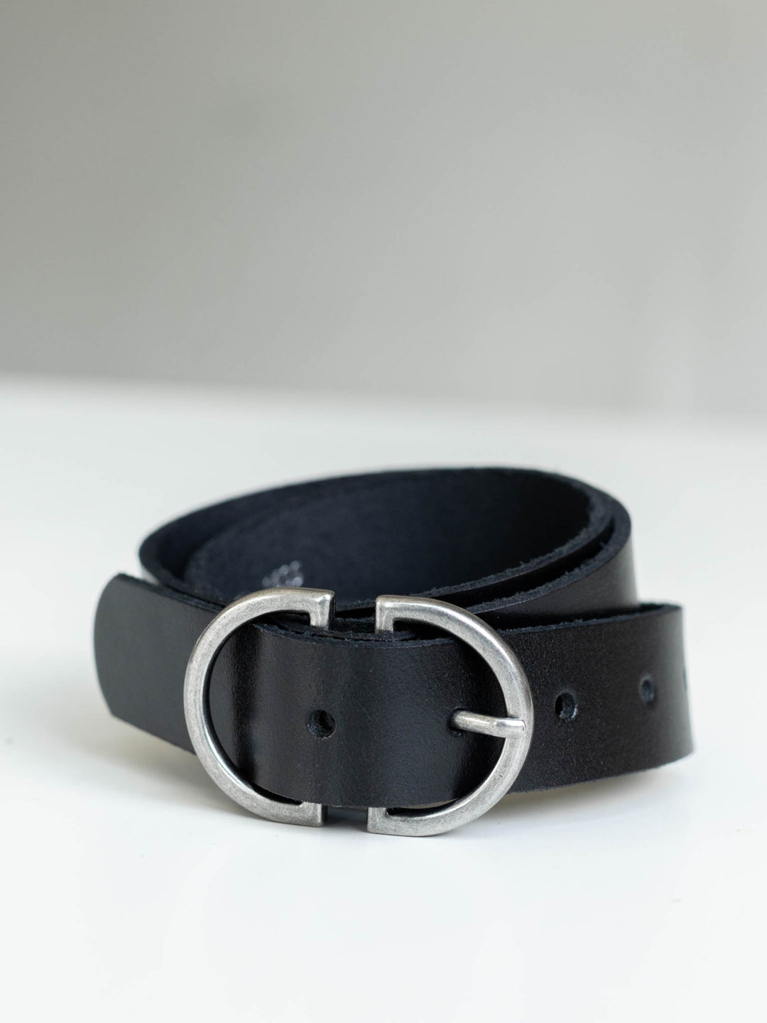 Black genuine leather belt with a striking silver D-ring buckle.