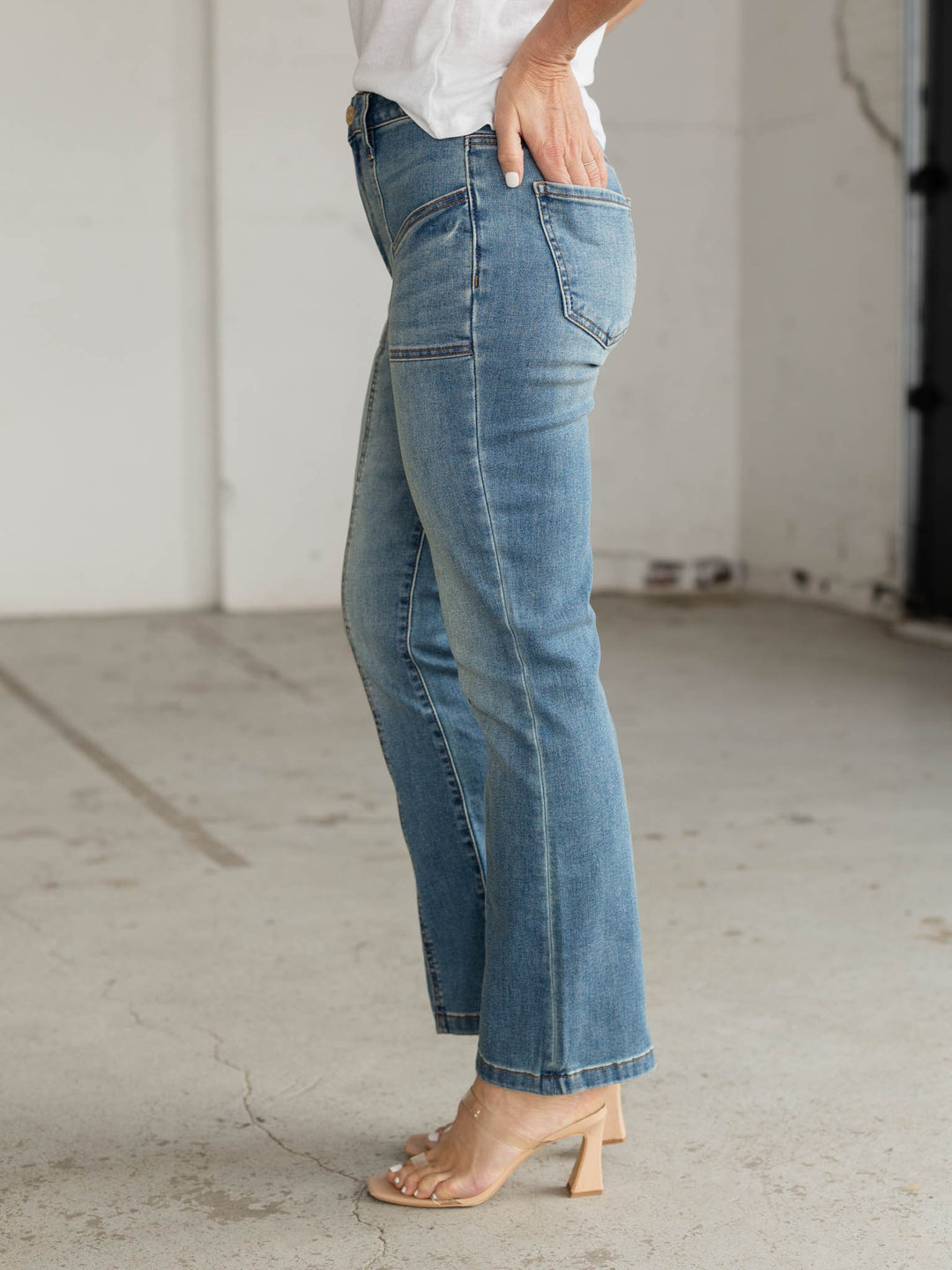 Person wearing light blue jeans in an indoor setting
