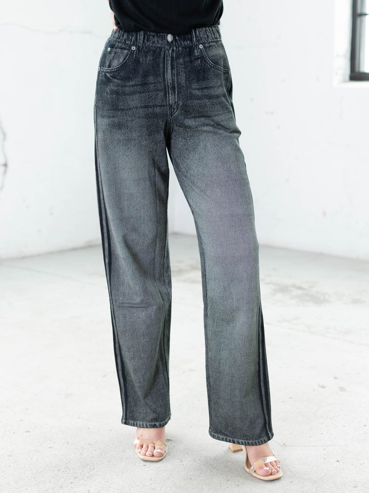 Person wearing gray jeans on a white background