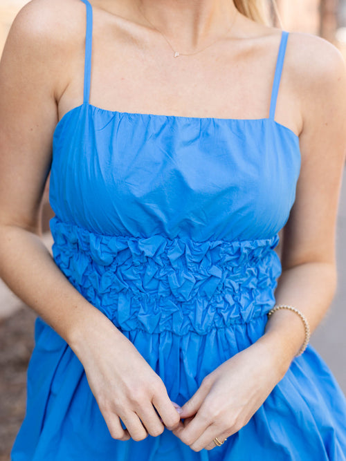bold blue smocked waist bubble mini dress