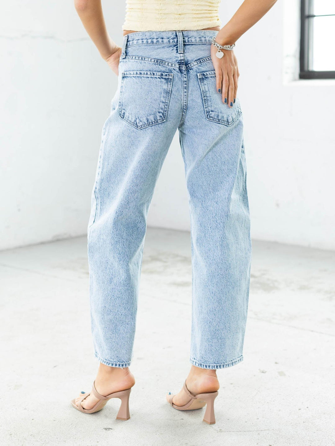 Light blue jeans worn by a person on a white background