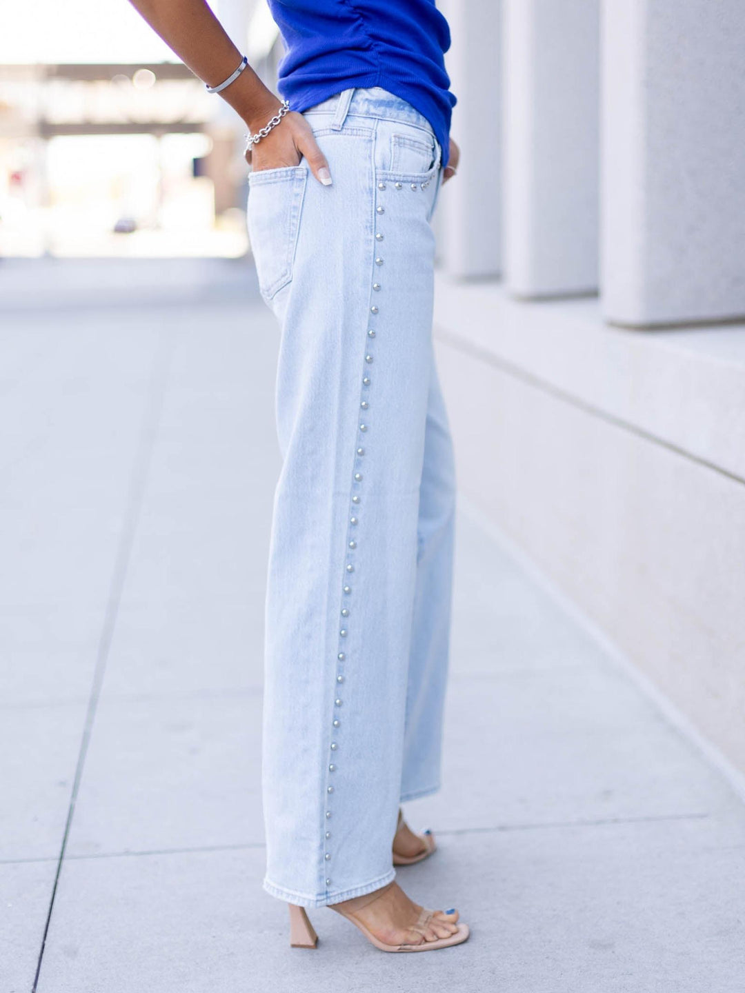 studded light wash denim jeans
