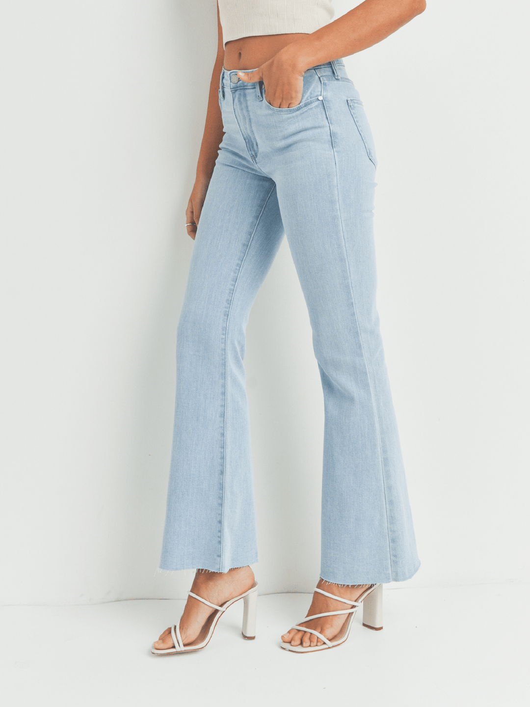 Light blue jeans worn by a person on a white background
