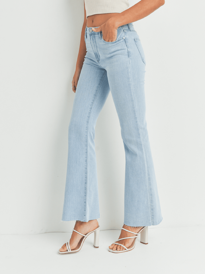 Light blue jeans worn by a person on a white background