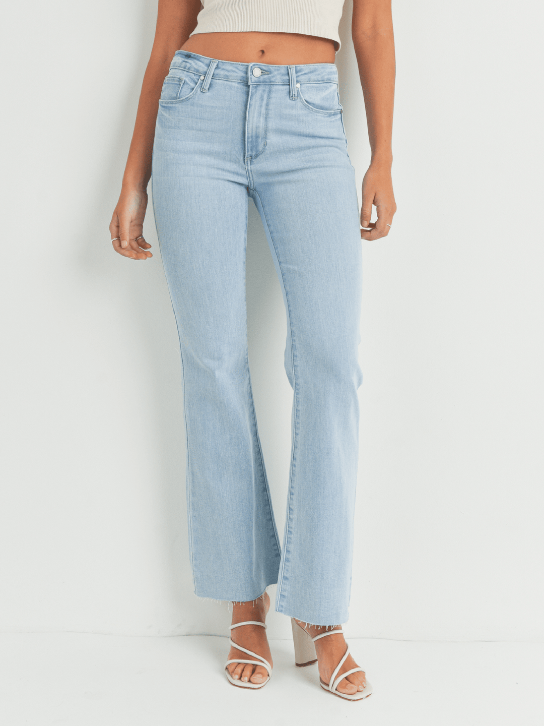 Light blue jeans worn by a person on a white background