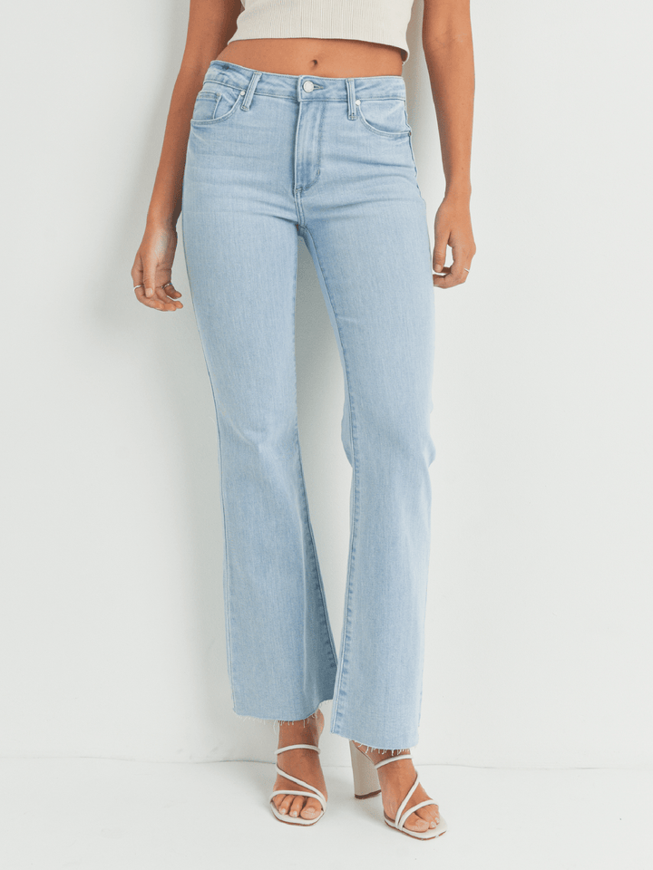 Light blue jeans worn by a person on a white background