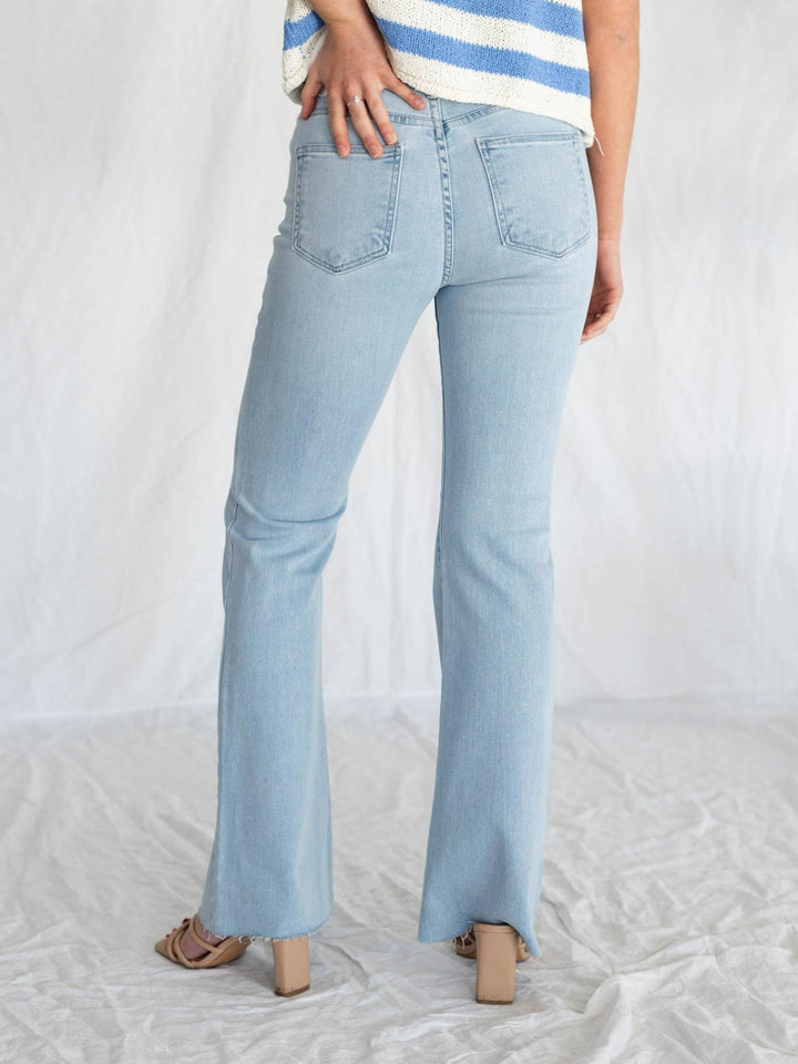 light wash blue jeans with rough cut hemline
