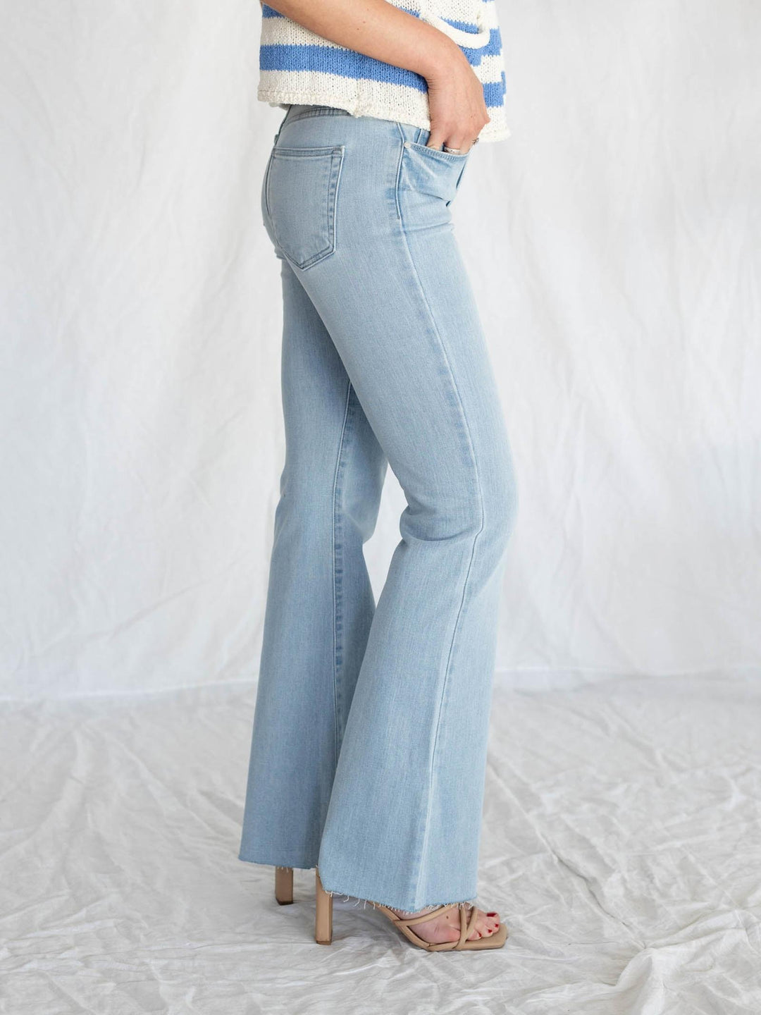 light wash blue jeans with rough cut hemline
