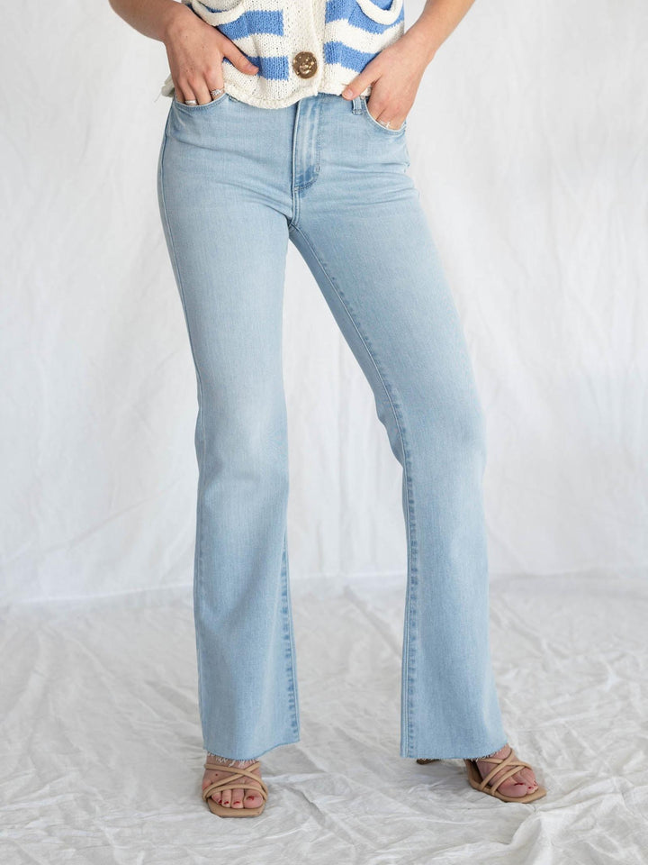 light wash blue jeans with rough cut hemline