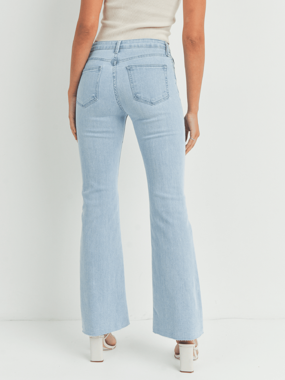 Light blue jeans worn by a person on a white background