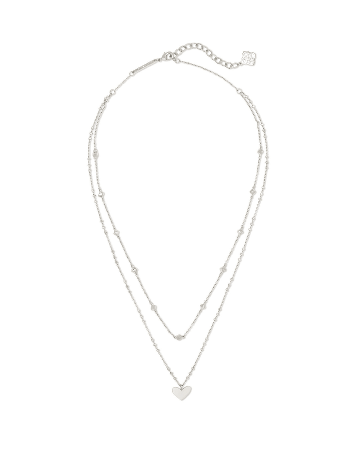 A delicate silver double-strand necklace with a small heart-shaped pendant, displayed on a clean white background.