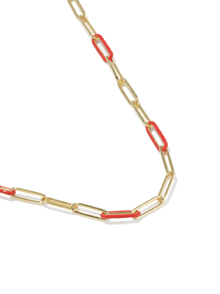 A gold paperclip chain necklace with alternating red paperclip links, shown on a clean white background.